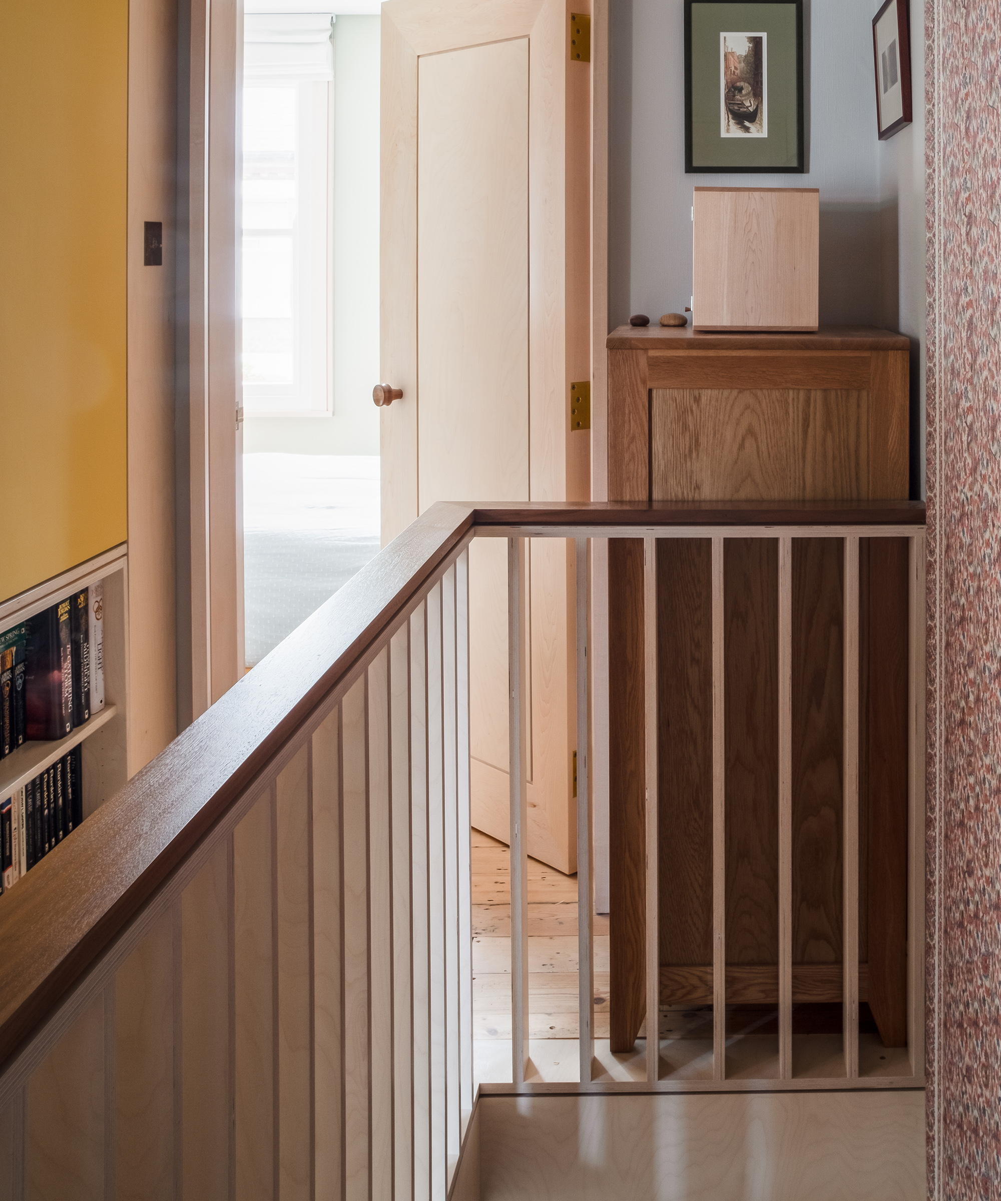 A narrow landing with plywood bannister rail