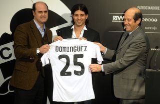 Fernando Gomez, left, welcomes Chori Dominguez to Valencia in his role as sporting director, with president Manuel Llorente to the player's right.