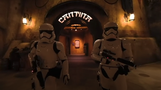Two stormtroopers stand outside of Oga's Cantina at Disneyland. 