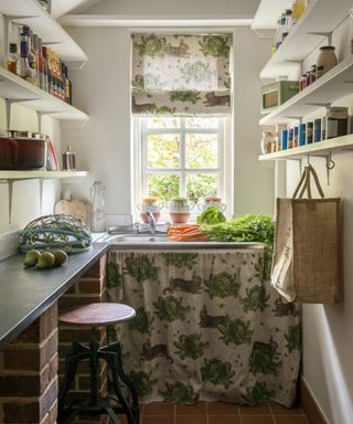 A small utility room idea with Thornback and Peel fabric in a cabbage and rabbit print on the blinds and curtain under the sink