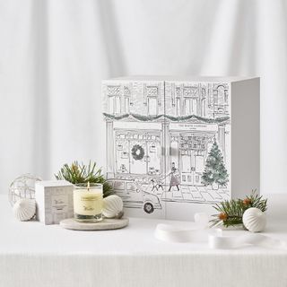 The White Company advent calendar with candles and bottles on a white background