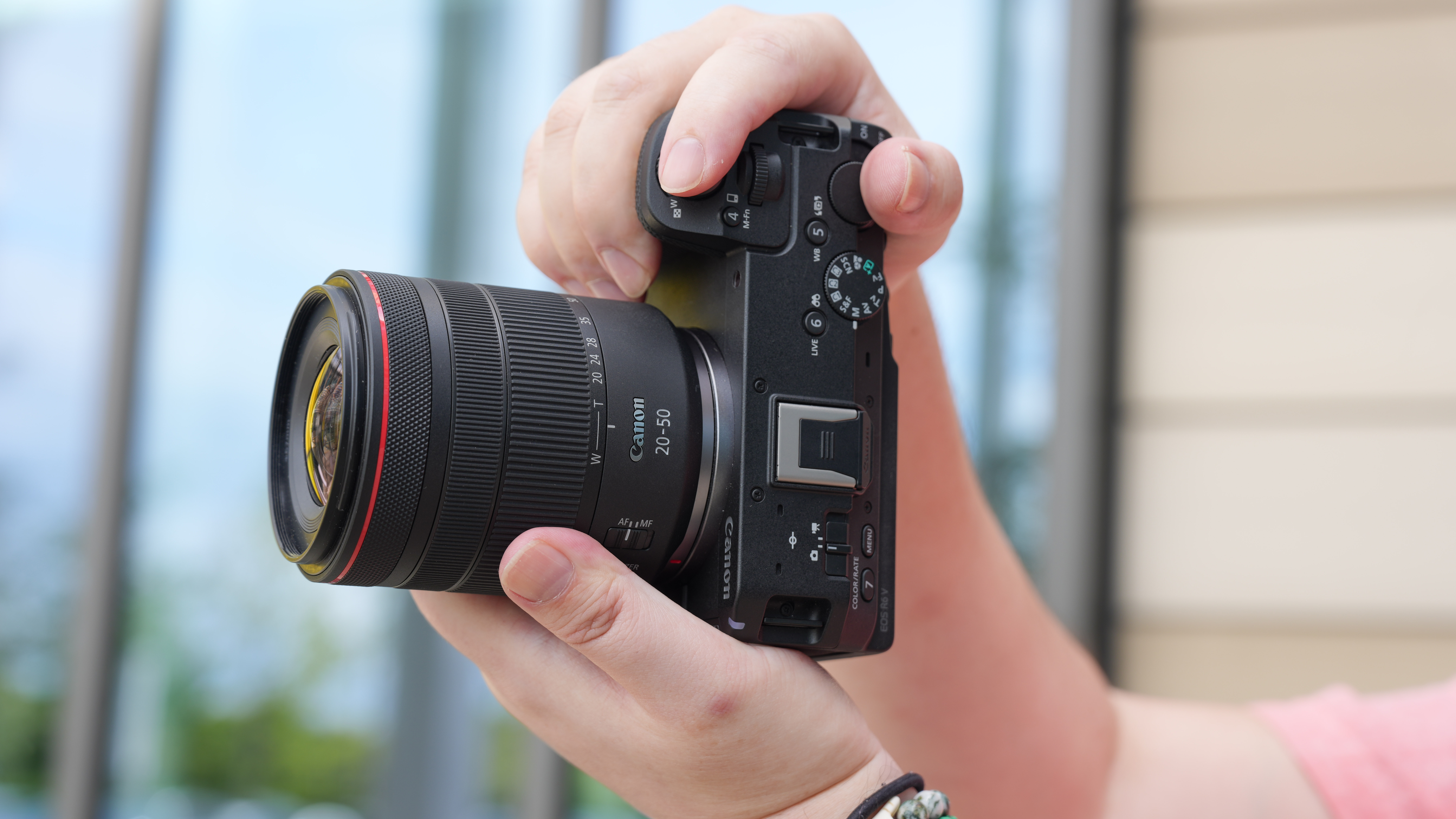 Canon EOS R6 V with the Canon RF 20-50mm f/4L IS USM PZ being held outdoors