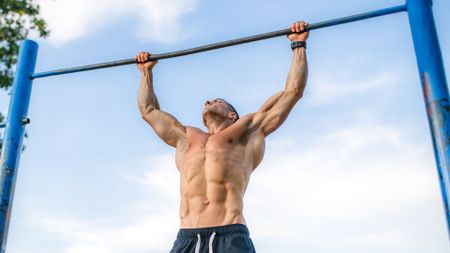 Fit young man doing chin ups