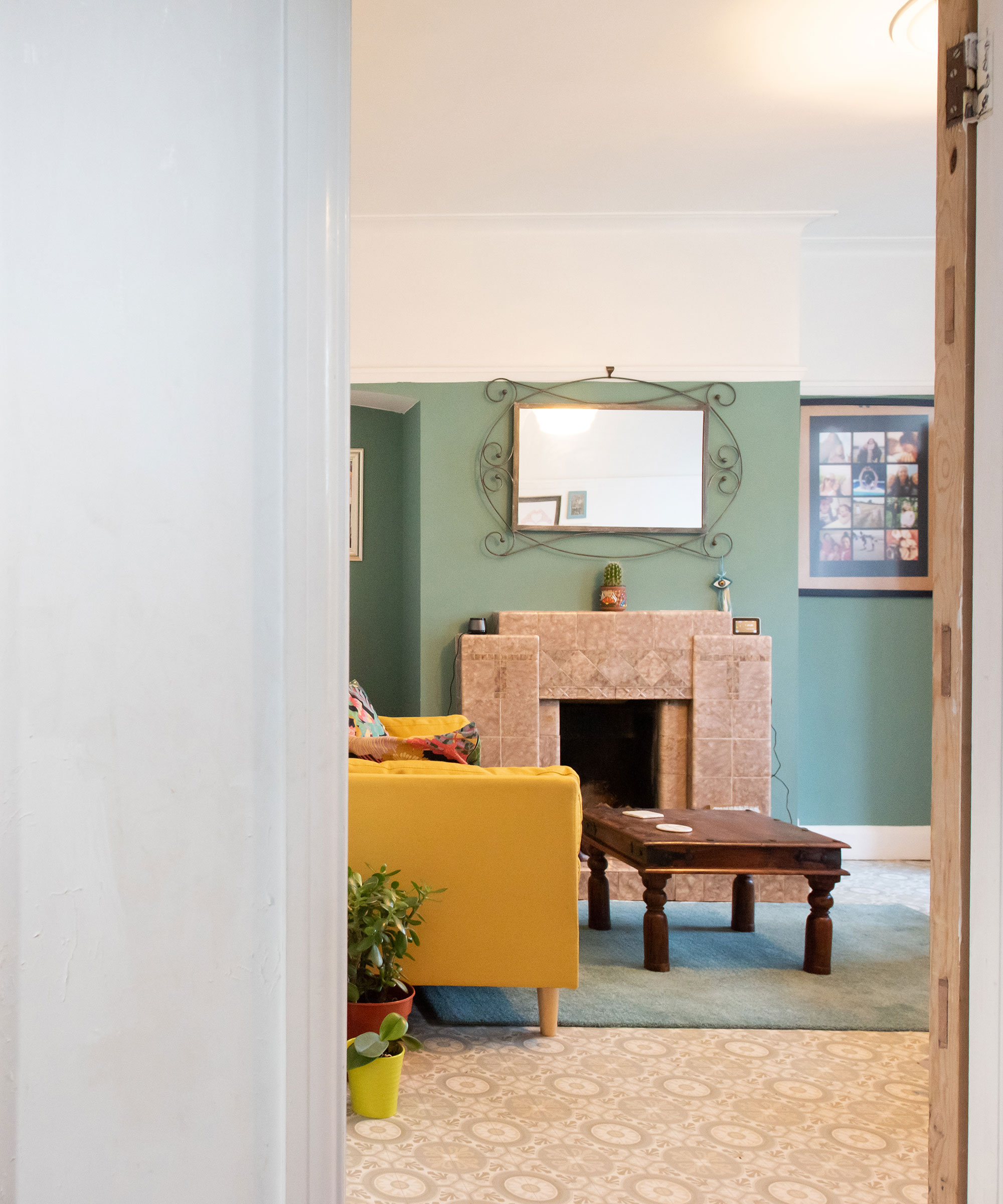 green living room with beige tiled 1950s fireplace and yellow retro sofa