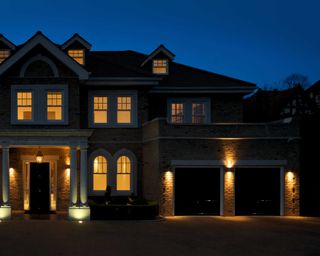 exterior shot of house with driveway lighting