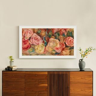 Wall-mounted Samsung TV with image of painted roses and a wooden sideboard below