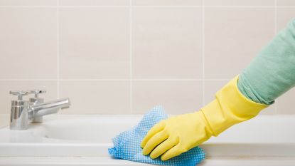 Person cleaning bathroom