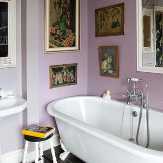 bathroom with photoframes on purple wall