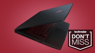 MSI GF65 gaming laptop partially closed on red background