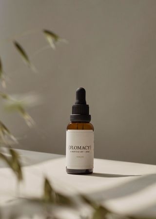 brown glass bottle of floral remedy by Flomacy