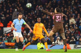 MANCHESTER, ENGLAND - FEBRUARY 11: Kylian Mbappe of Real Madrid shoots past Ederson of Manchester City in the build up to his side's third goal during the UEFA Champions League 2024/25 League Knockout Play-off first leg match between Manchester City and Real Madrid C.F. at Manchester City Stadium on February 11, 2025 in Manchester, England. (Photo by Chris Brunskill/Fantasista/Getty Images) Jamie Carragher