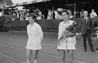 American tennis player Billie Jean King and British tennis player Virginia Wade, holding a bouquet of flowers, following the Women's Singles Final of the 1968 US Open