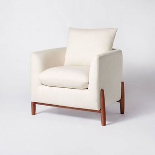 A cream sherpa armchair with wooden legs is one of the best Target furniture pieces.