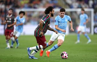 Marcelo of Fluminense runs with the ball whilst under pressure from Julian Alvarez of Manchester City during the FIFA Club World Cup Saudi Arabia 2023 Final between Manchester City and Fluminense at King Abdullah Sports City on December 22, 2023 in Jeddah, Saudi Arabia.