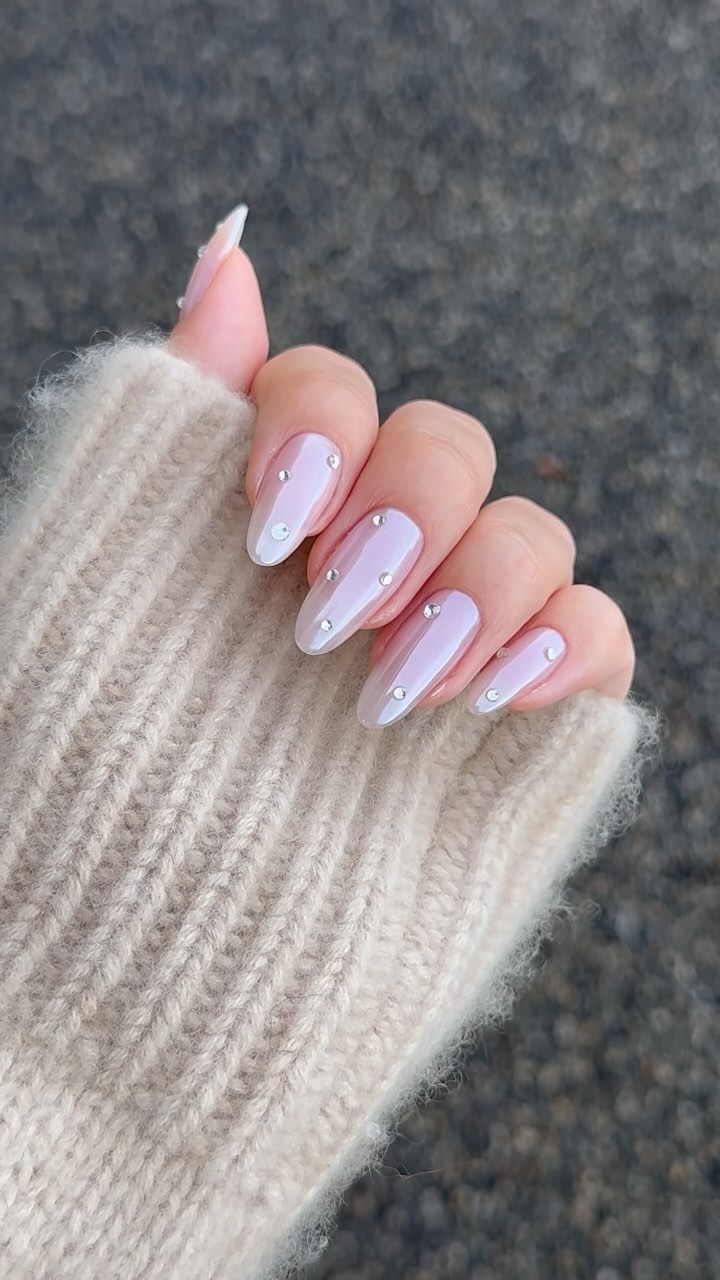 Transparent pink chrome nails with gem dots
