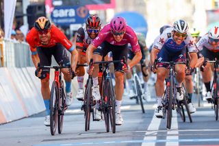Team Groupama-FDJ's French rider Arnaud Demare (C) sprints in the last meters to cross the finish line to win, ahead of Team Bahrain's German rider Phil Bauhaus (L) and Team Quick-Step Alpha Vinyl's British rider Mark Cavendish (R) the 13th stage of the Giro d'Italia 2022 cycling race, 150 kilometers from San Remo to Cuneo, northwestern Italy, on May 20, 2022. (Photo by Luca Bettini / AFP) (Photo by LUCA BETTINI/AFP via Getty Images)