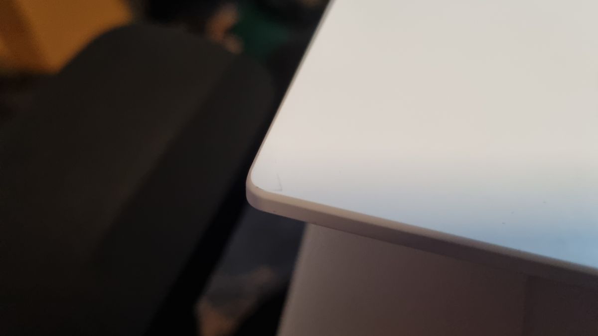 The corner of the Lenovo Legion 7 gaming laptop, showing marks and signs of wear on the white finish