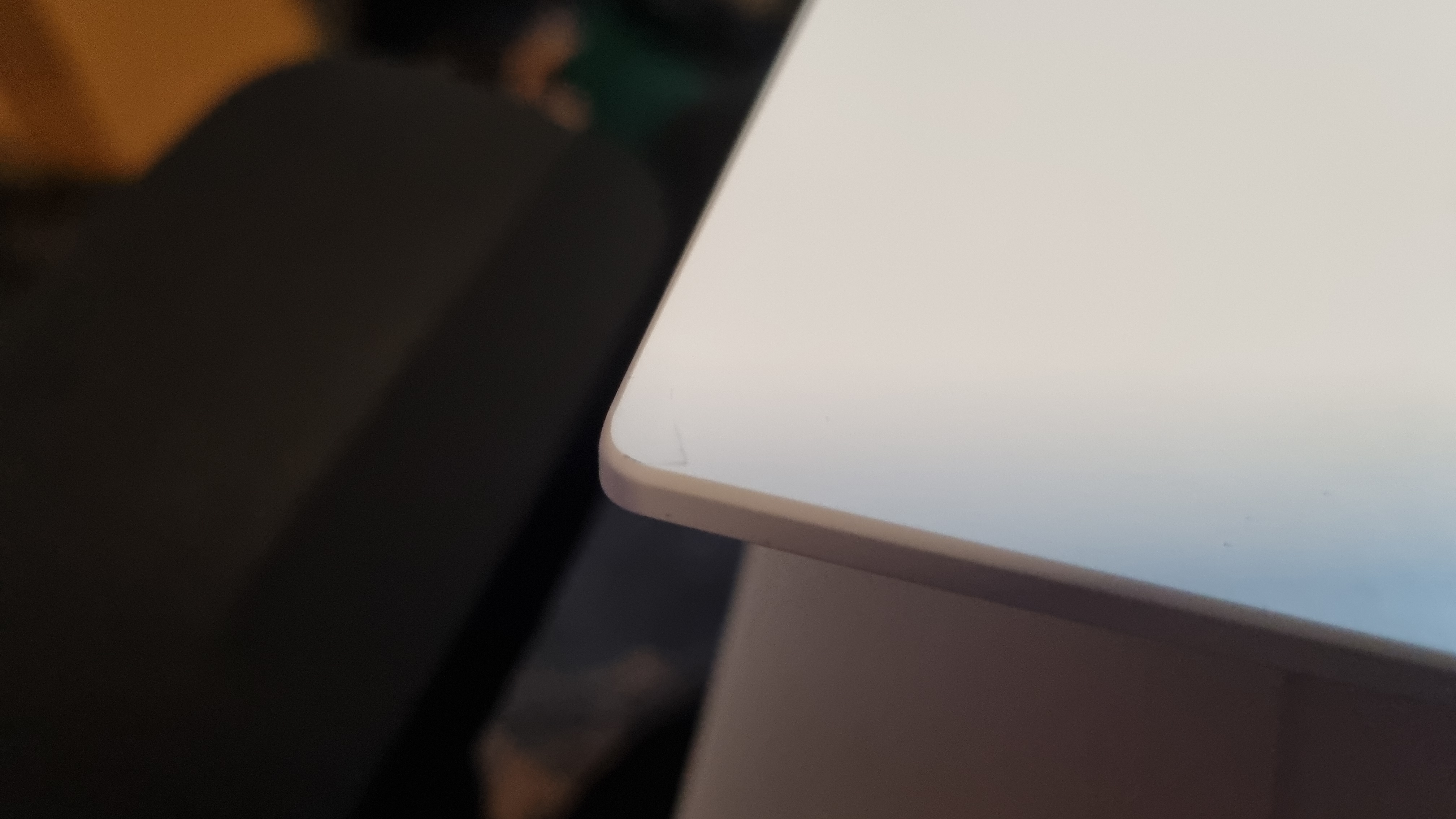 The corner of the Lenovo Legion 7 gaming laptop, showing marks and signs of wear on the white finish