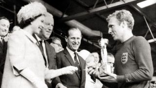 Queen Elizabeth II hands the Jules Rimet trophy to England captain Bobby Moore