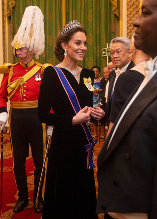 Catherine, Duchess of Cambridge talks to guests at an evening reception for members of the Diplomatic Corps at Buckingham Palace on December 11, 2019 in London, England
