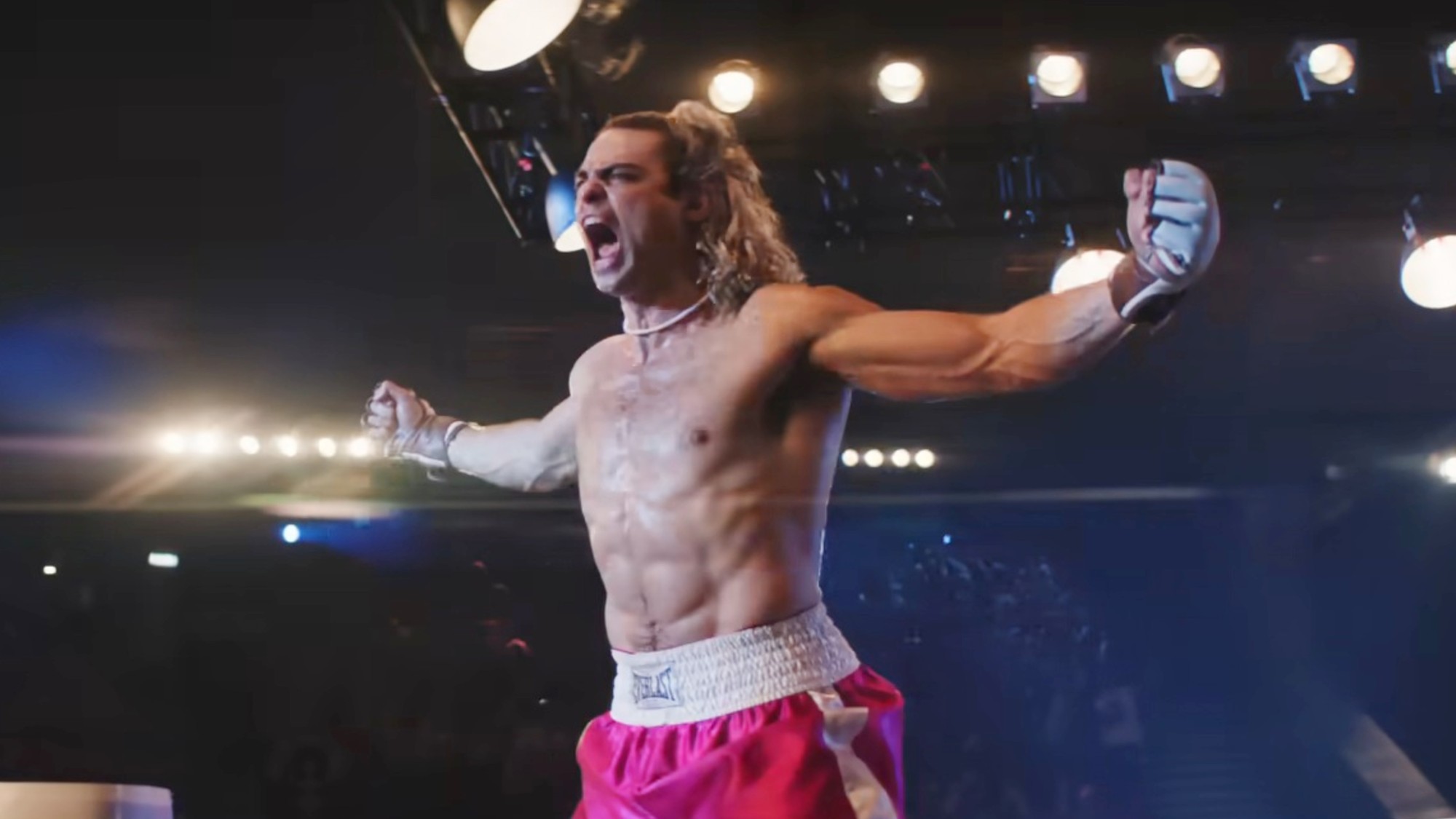 Noah Centineo with his arms outstretched in victory in Street Fighter