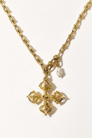 gold necklace with gold pendant and pearl pendant