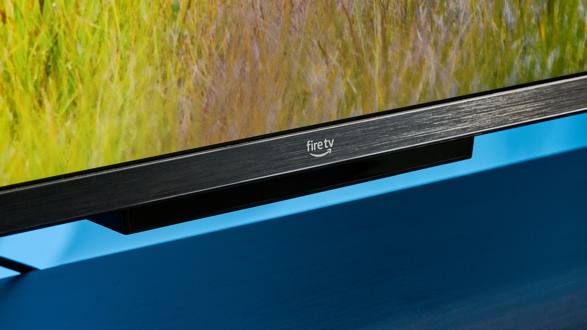 the amazon ember 4-series TV photographed against the blue tom's guide background