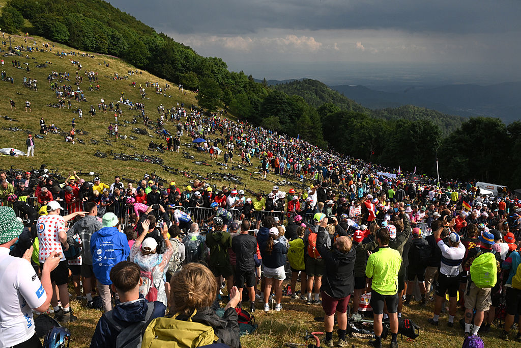 A general view of the peloton compete climbing to the Col du Haag (1225m) while fans cheers during the 113th Tour de France 2026 - Stage 14 a 155.3km a 155.3km stage from Mulhouse to Le Markstein 1189m / #UCIWT / on July 18, 2026 in Le Markstein, France. (Photo by Dario Belingheri/Getty Images