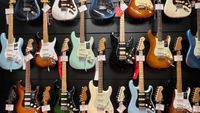 A guitar store wall displaying Fender guitars 