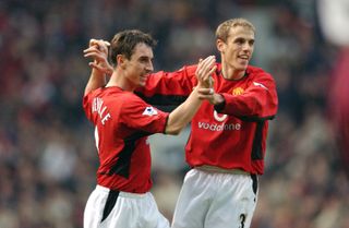 Gary and Phil Neville celebrate a goal for Manchester United against West Ham in December 2002.