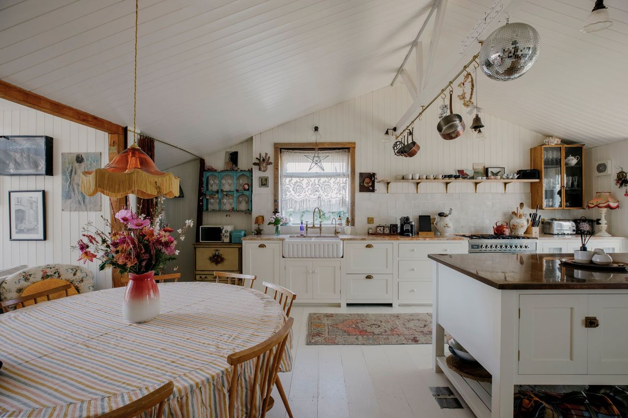 The kitchen-diner has a kitchen island and table in the corner