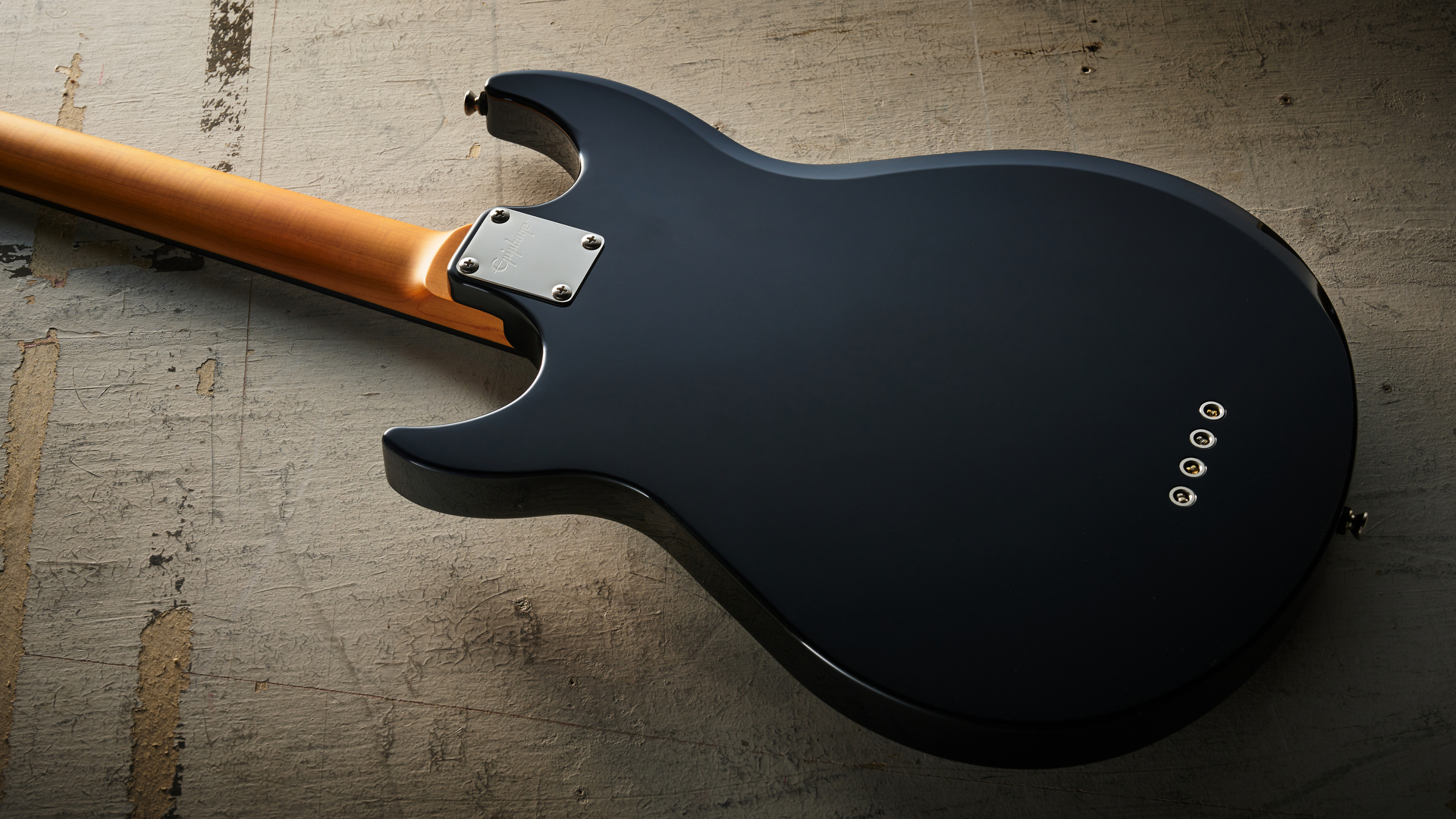 Epiphone Mike Dirnt Grabber G-3 in Silverburst finish photographed on scratched white board.