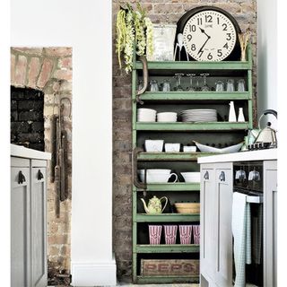 white kitchen with green shelves and drawers