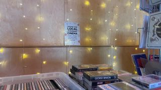 Boxes of CDs and cassettes, fairy lights and a sign supporting local cinema