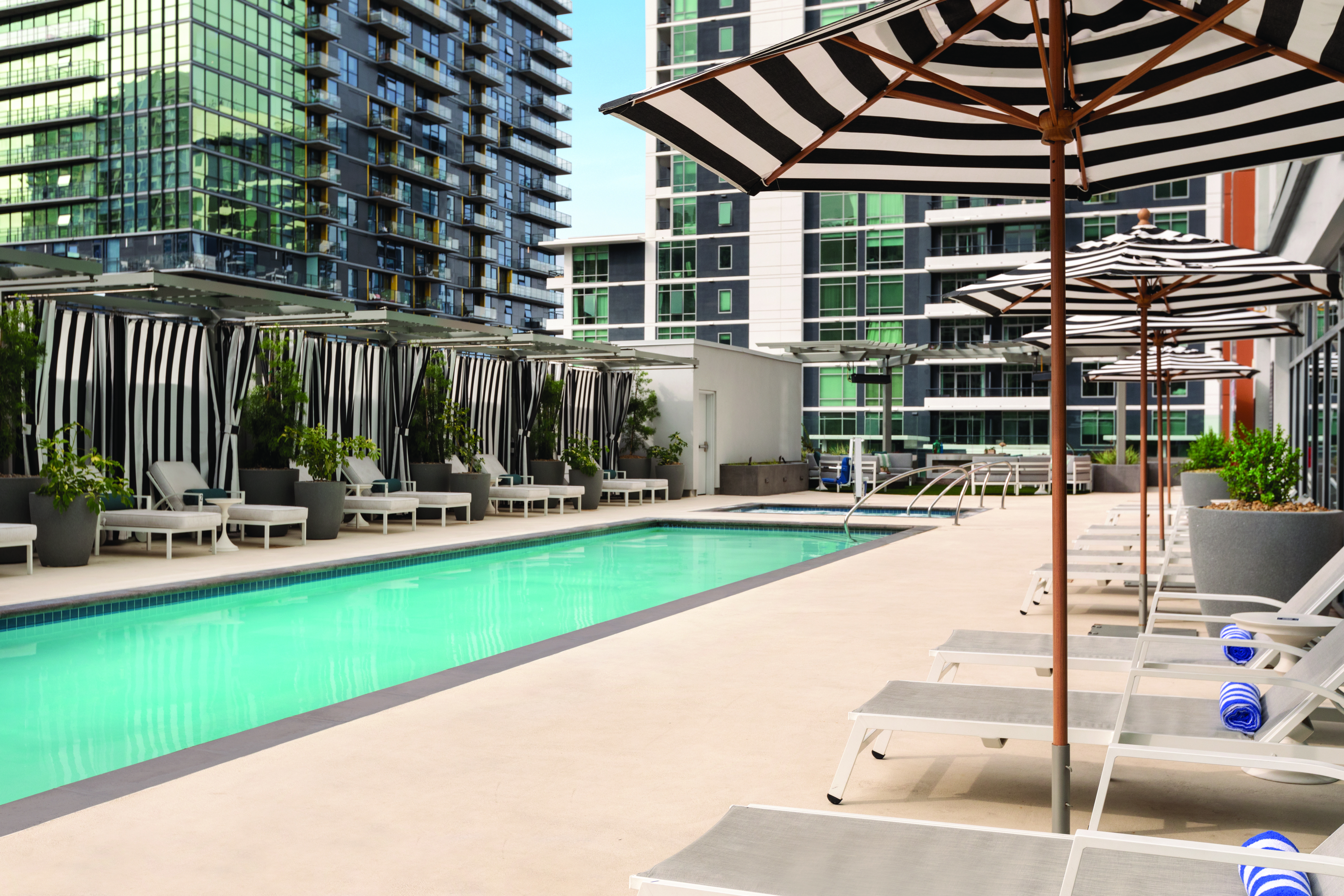The pool and striped umbrellas at Cart&amp;eacute; Hotel