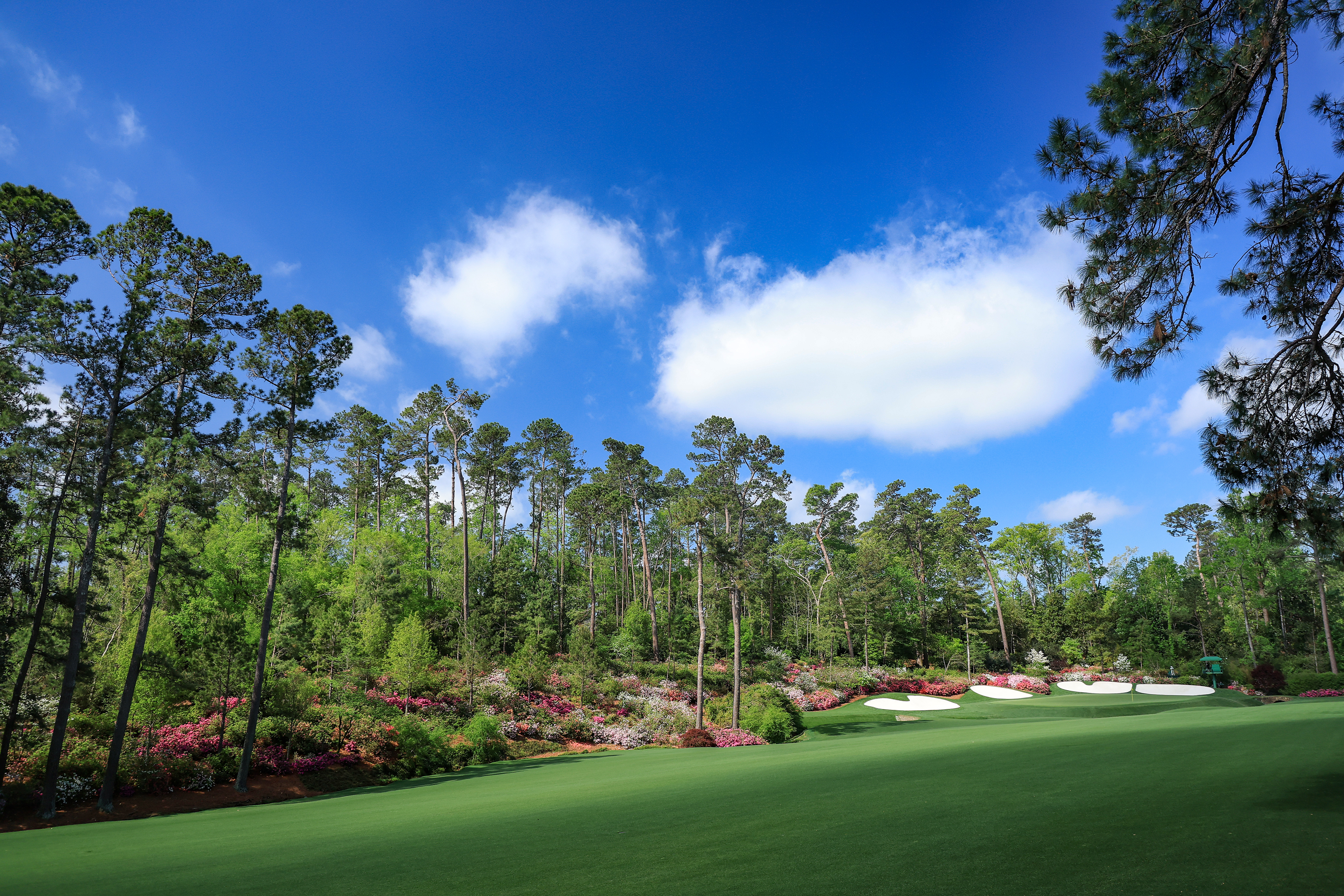 The 13th fairway and green at Augusta National on a sunny day