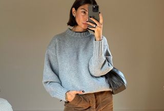 woman in gray sweater and brown pants