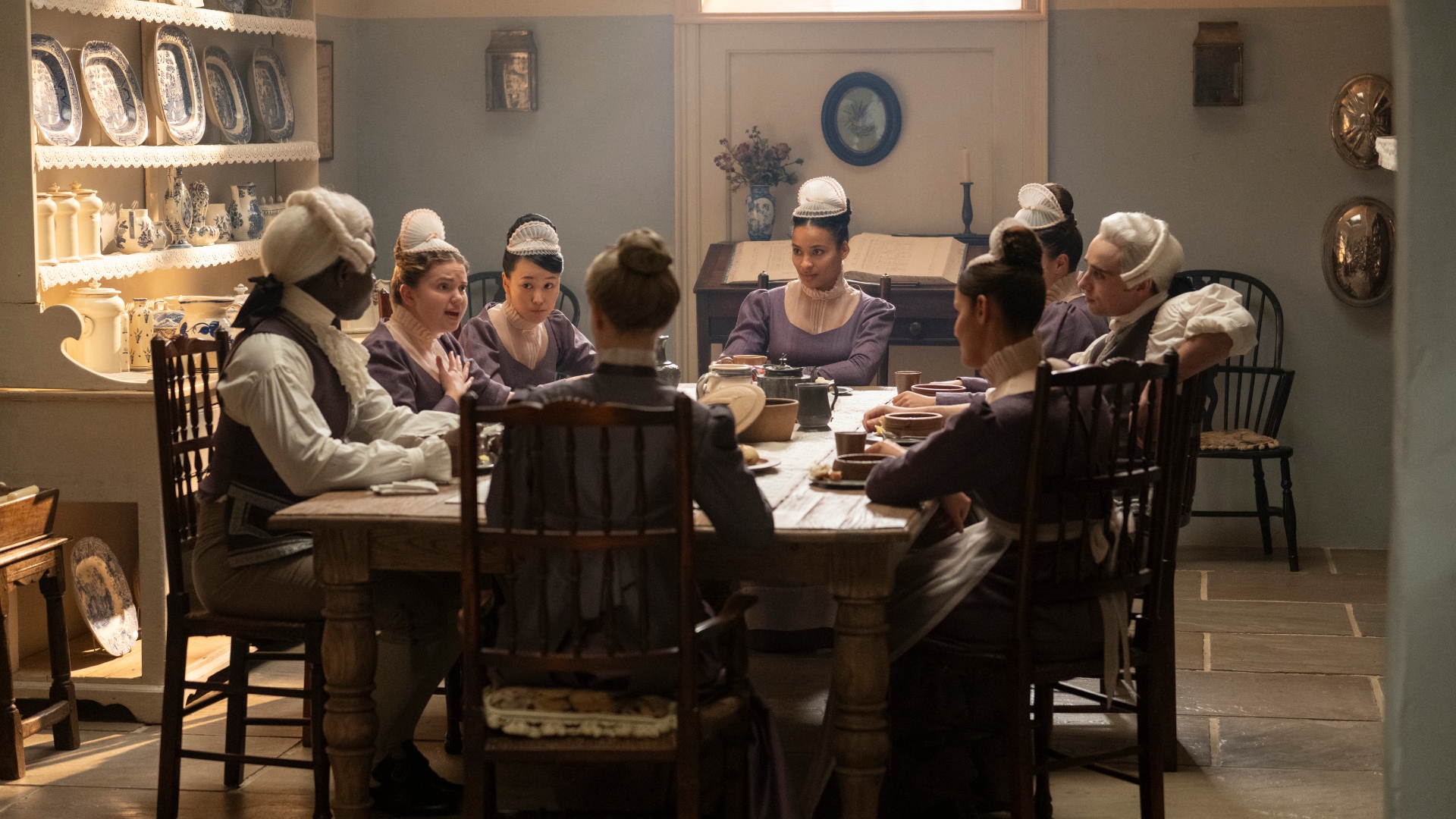 The house staff talk around a table in Bridgerton season 4