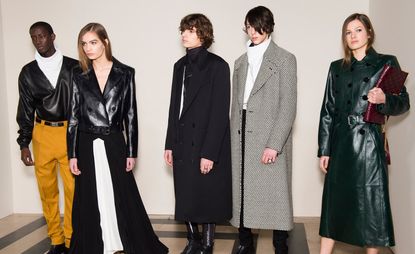 Multiple models can be seen wearing dark leather outerwear. Others wear check and block colour coats.