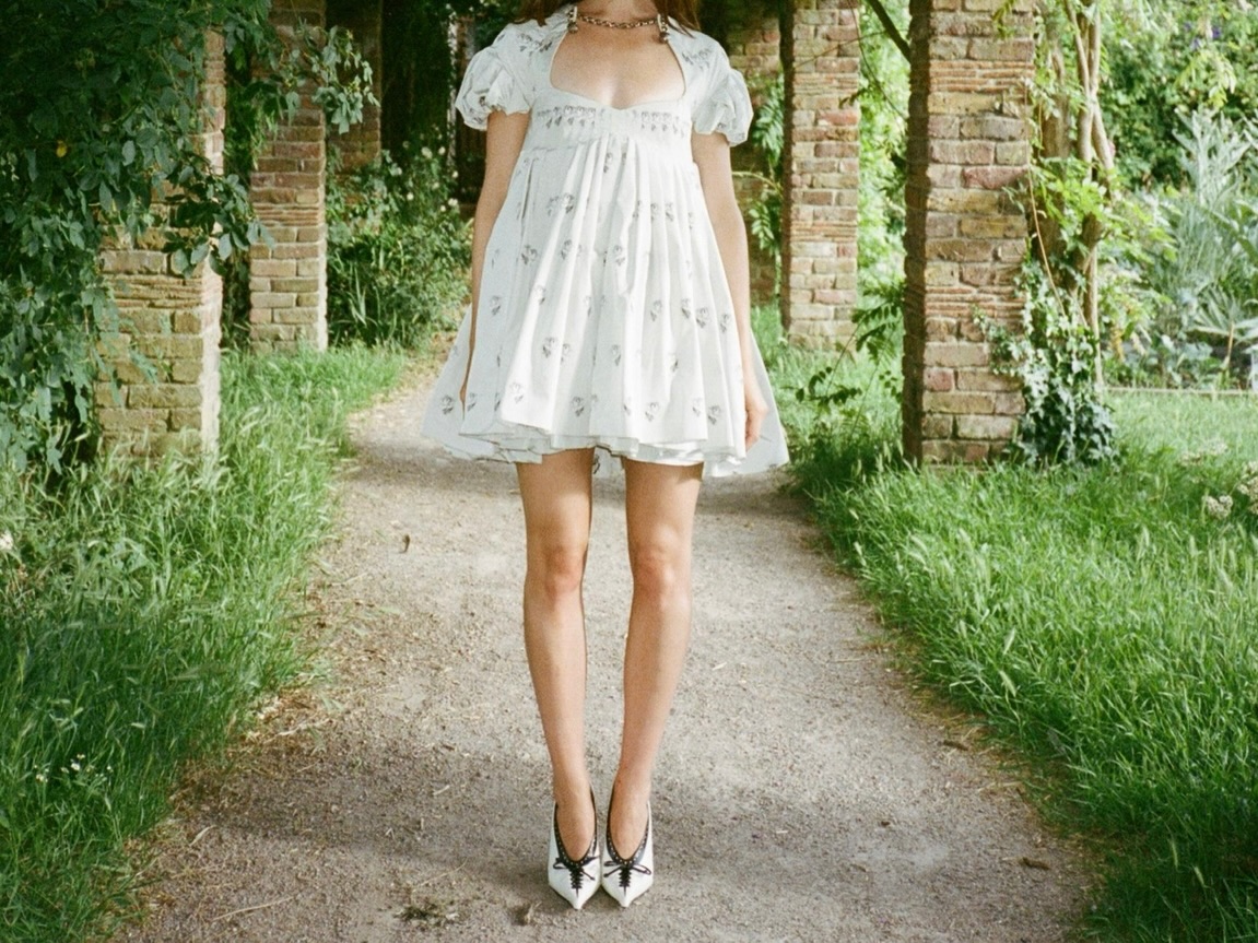 Daisy Edgar-Jones styled a little white babydoll dress from McQueen with the lace-up heels trend