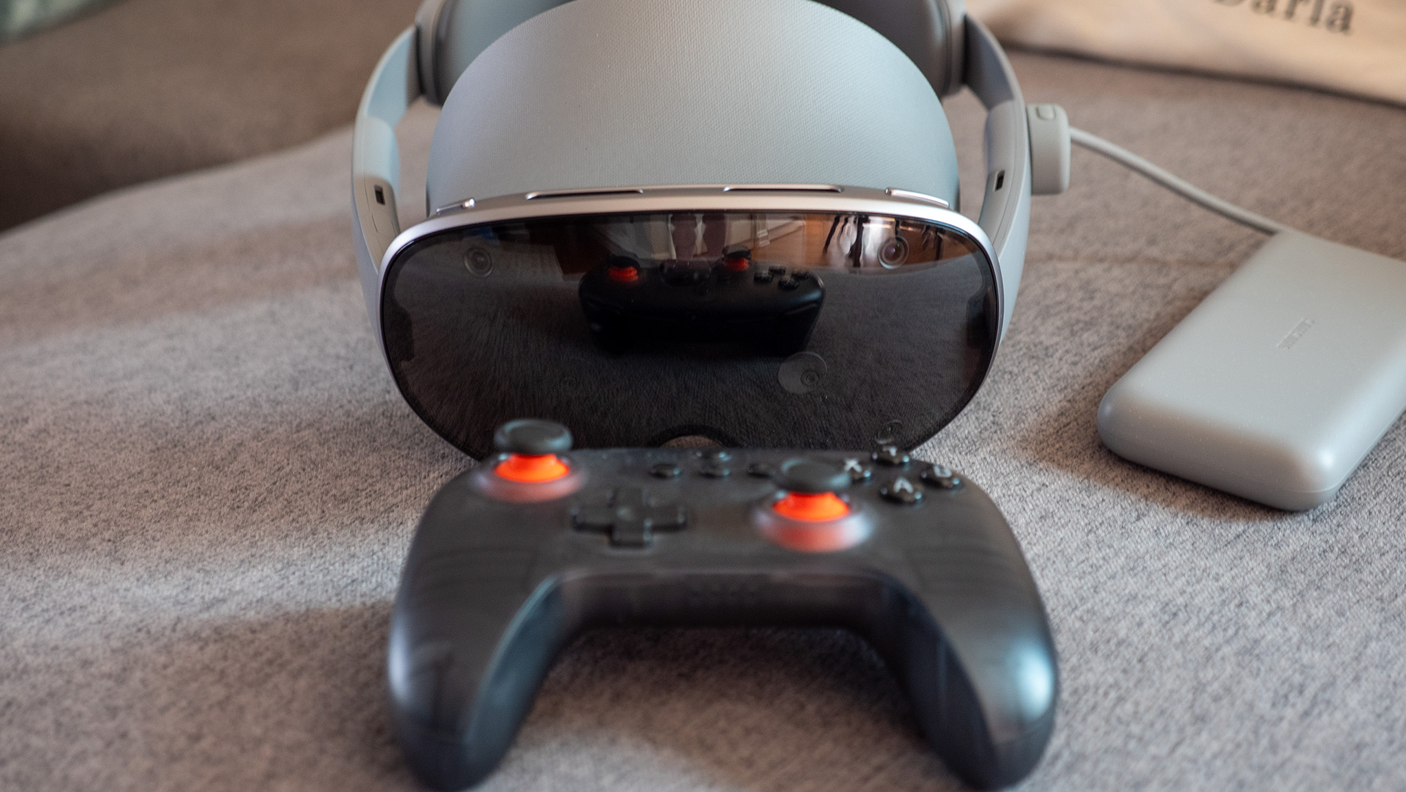 An 8BitDo controller in front of a Samsung Galaxy XR headset