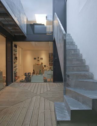 Wood flooring with steel stairway (with steel banisters) on the right leading to the lounge upstairs.