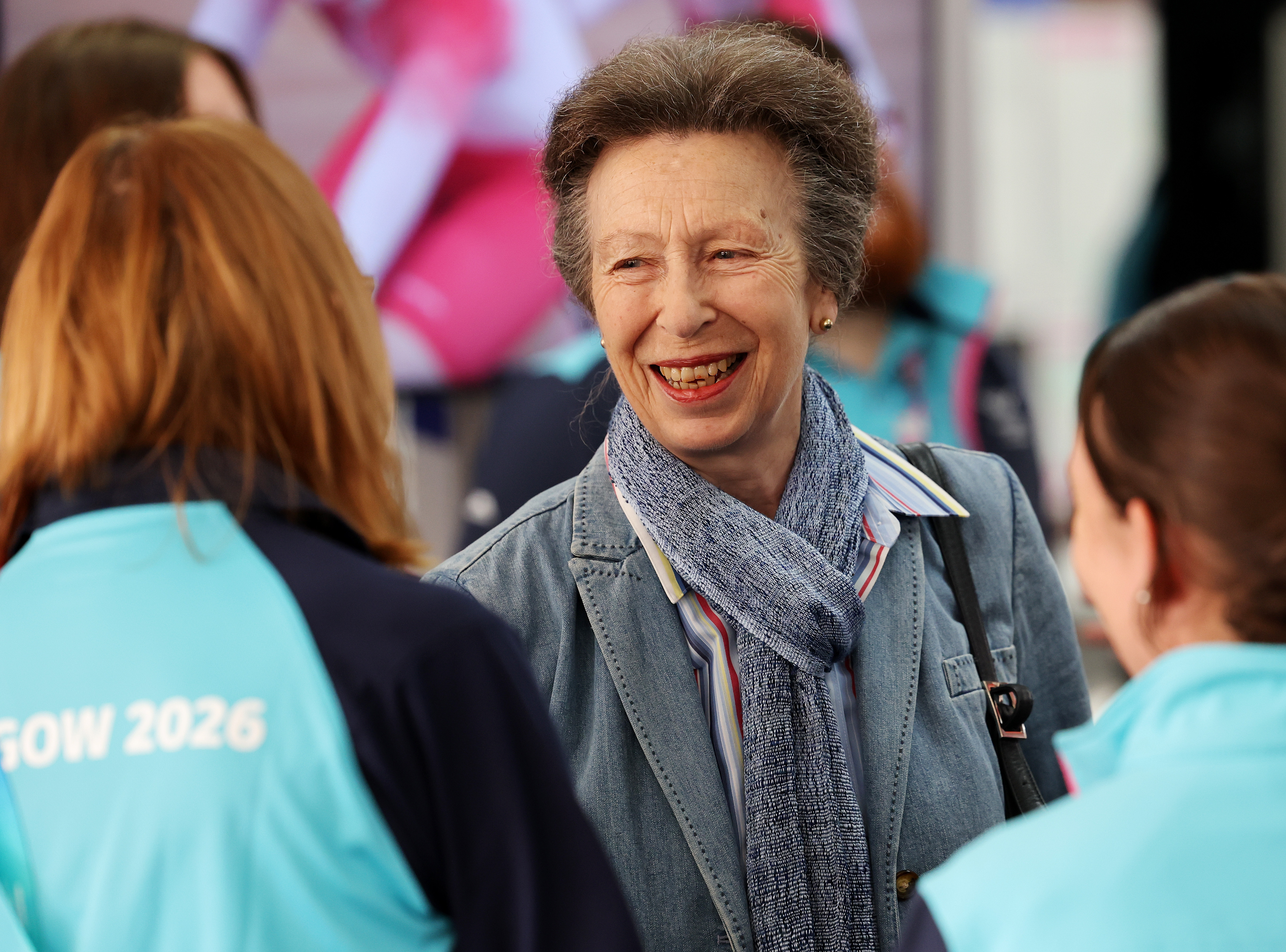 Princess Anne smiling at two women at the Commonwealth Games