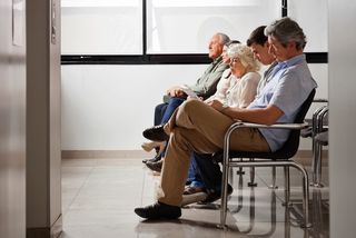 A number of people in the hospital's waiting room.