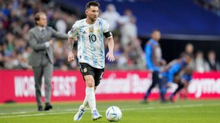 Lionel Messi on the ball for Argentina at the Copa America in the blue and white striped home kit