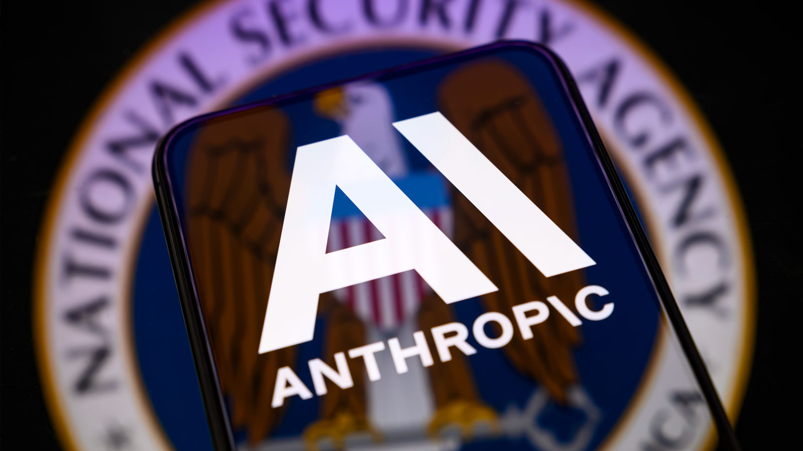NSA logo with Anthropic logo on phone screen.