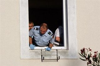 A French gendarme searches outside the window