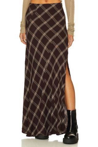 up close shot of Revolve model wearing a plaid maxi skirt and boots