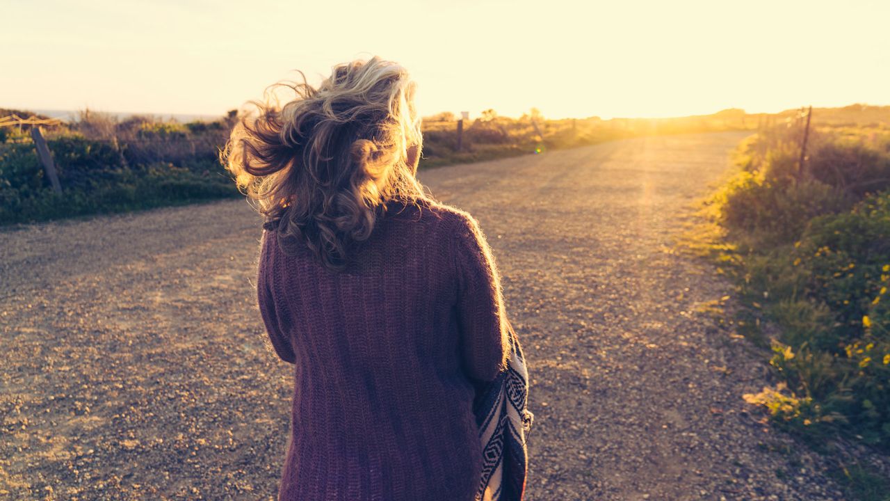 Woman walking into the sunset