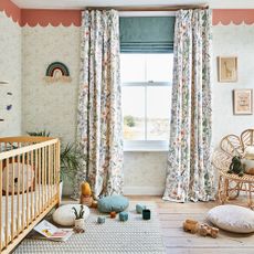 Girls nursery with woodland wallpaper and curtains and cot